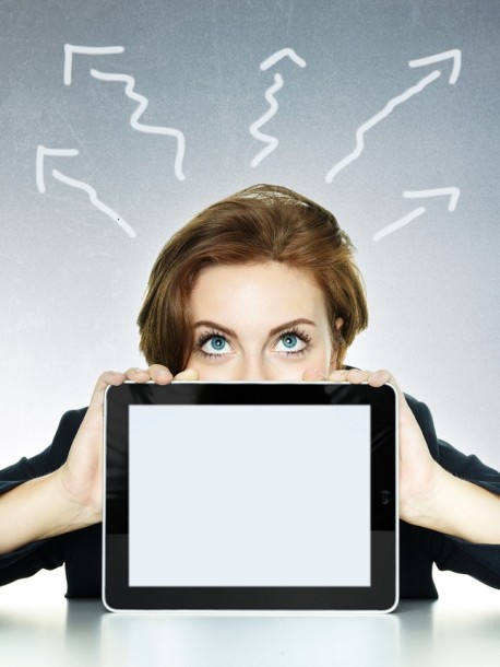 Business woman looking over her tablet pc with copyspace